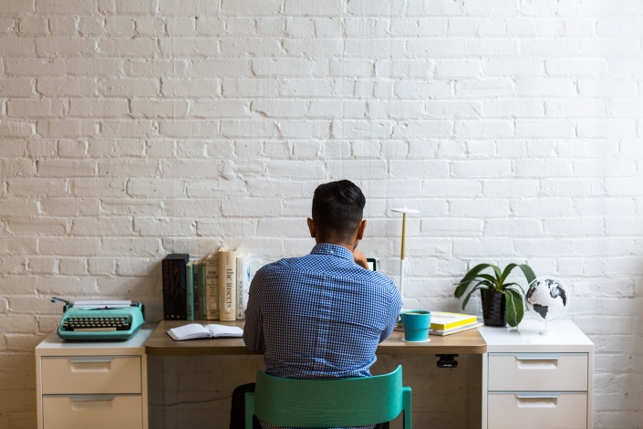 negative-space-man-working-desk-office-minimal-white-burst